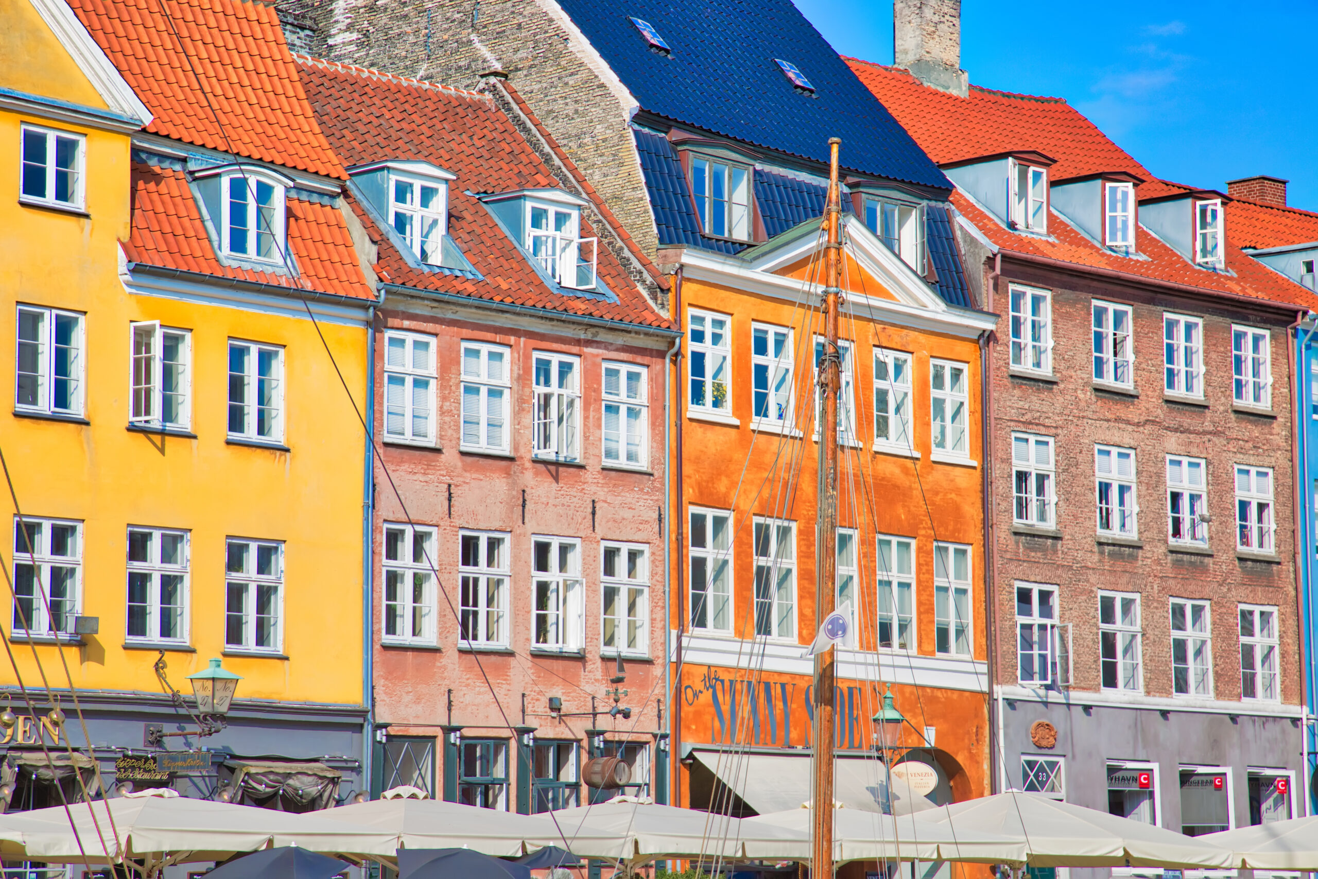 Copenhagen, Denmark-2 August, 2018: Famous Nyhavn (New Harbour) bay in Copenhagen, a historic 17 century European waterfront with colorful buildings. A starting point for boat and canal tours.